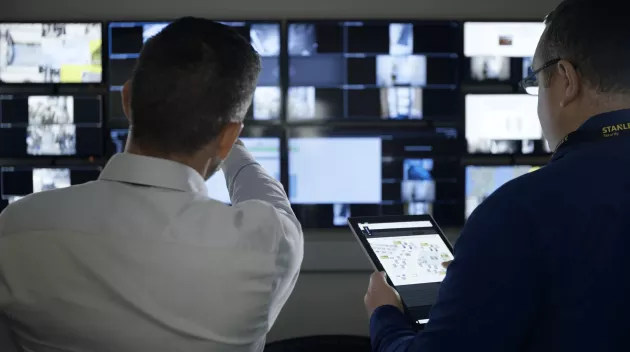 security officers remotely monitoring live security footage 
