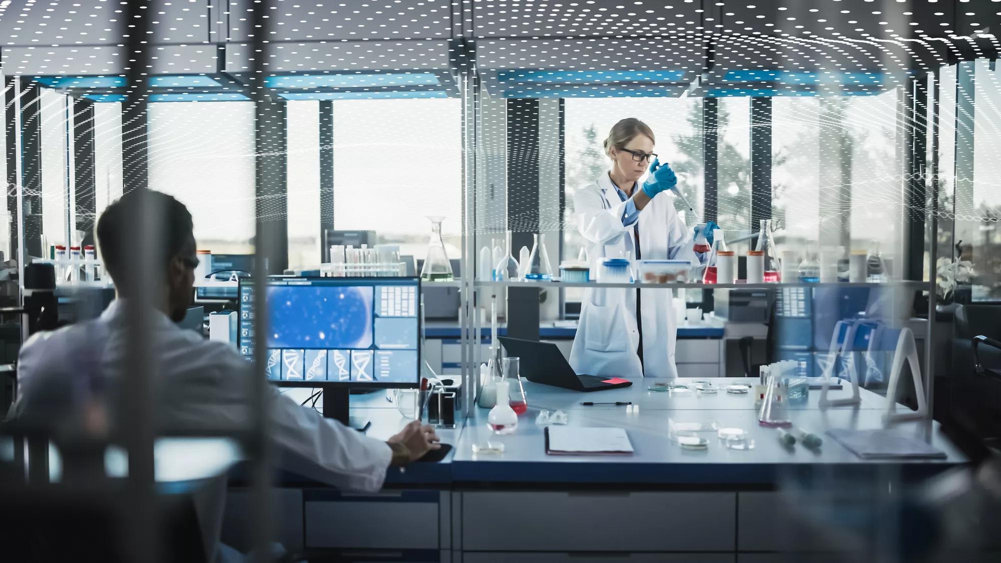 Female Medical Scientist Wearing White Coat and Safety Glasses uses Micropipette while Examining Testing Sample. Innovative, Experimental Drugs Research, Biotech Development in High-Tech Laboratory