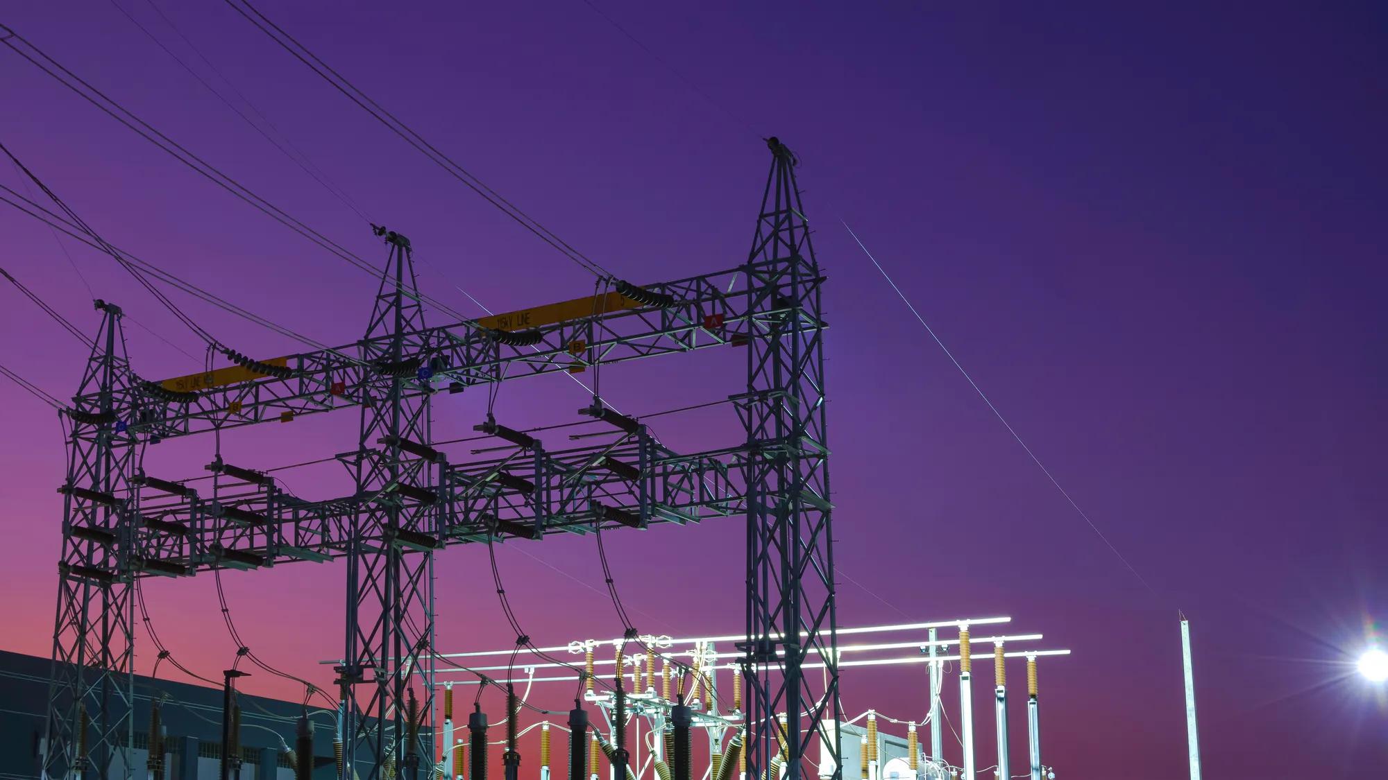 An electricity substation at night that requires physical security for critical infrastructure protection and energy security