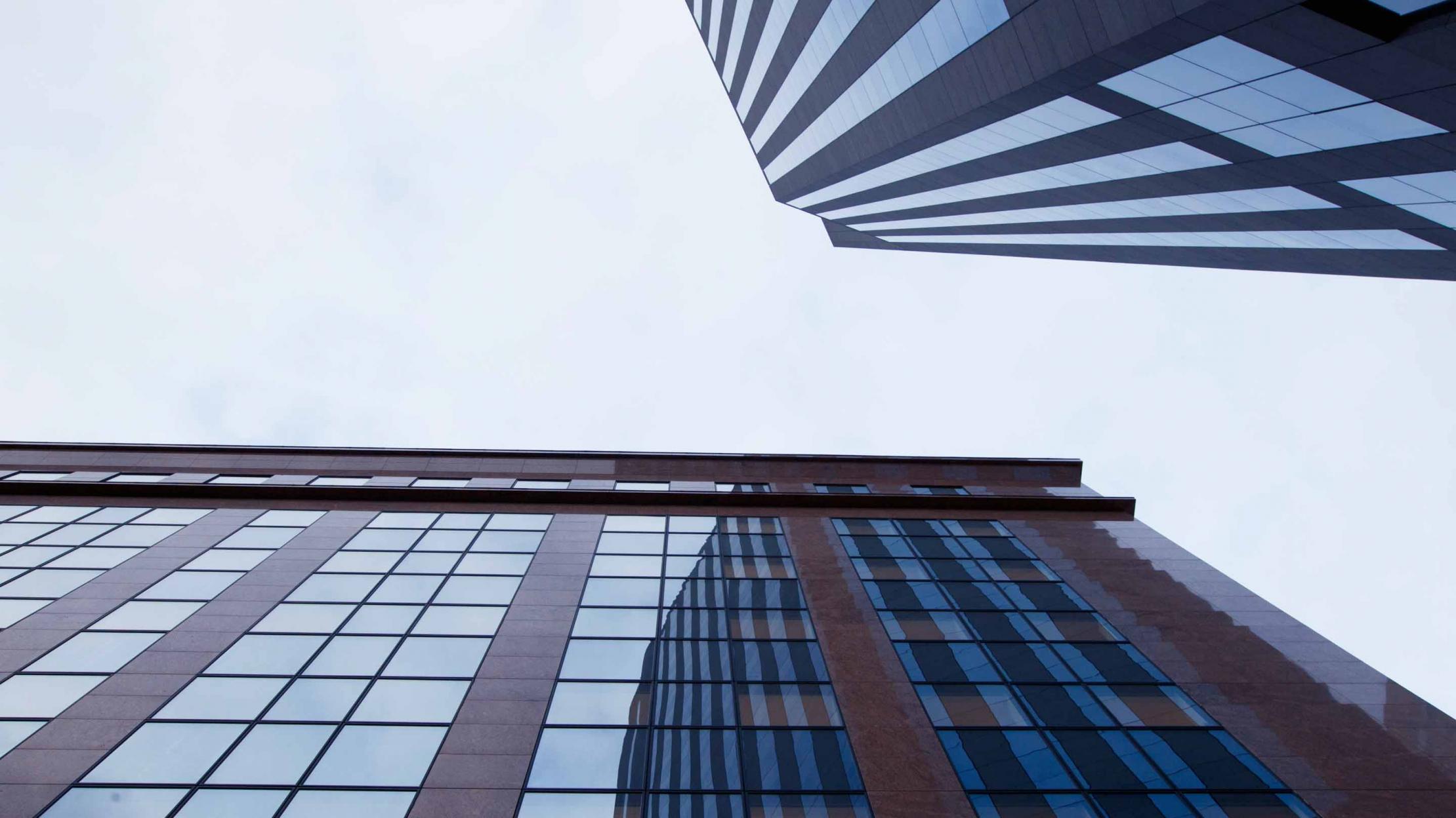 Two tall buildings against sky