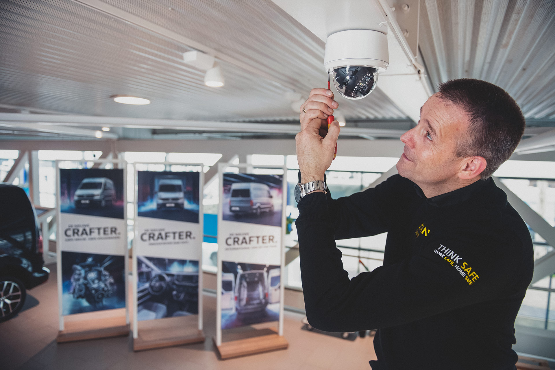 Man installs security camera in car dealership