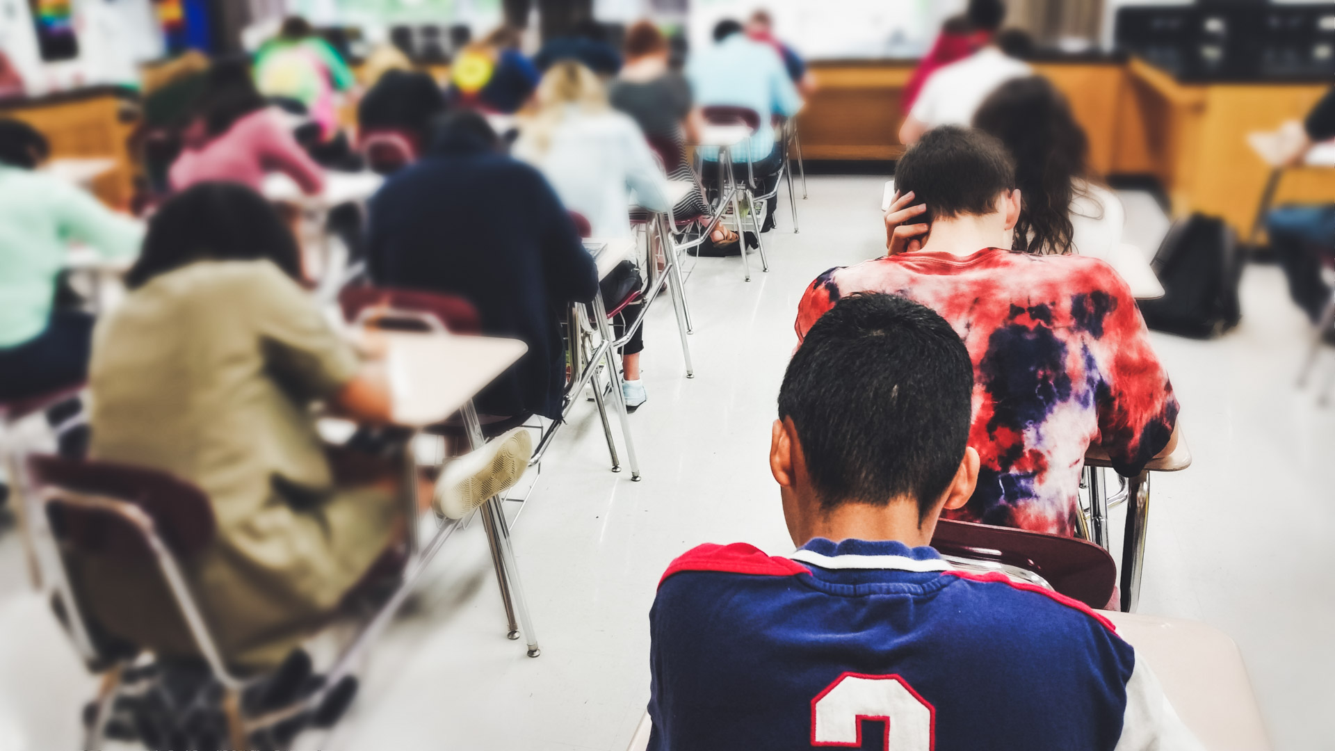 Students taking exam in classroom