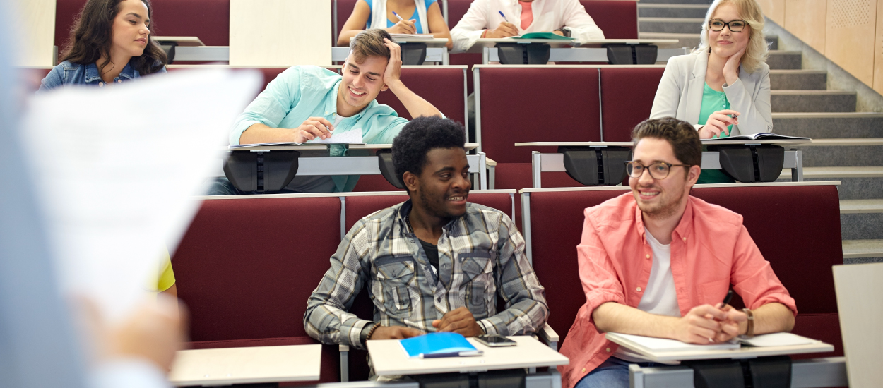 Students sit in a lecture hall waiting for class to start