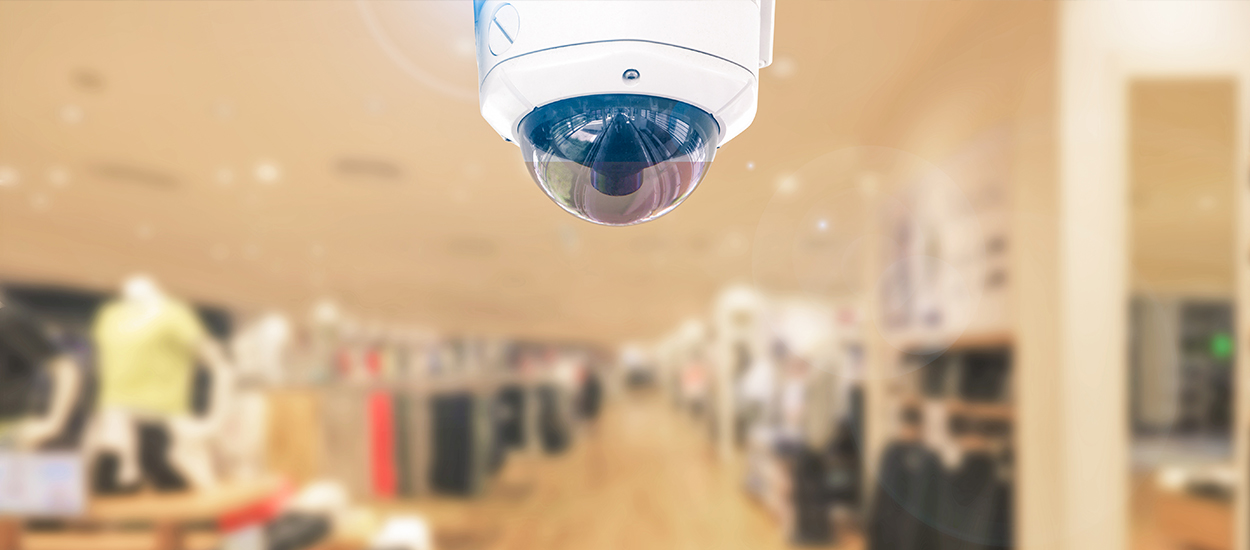 Security camera on ceiling of clothing store