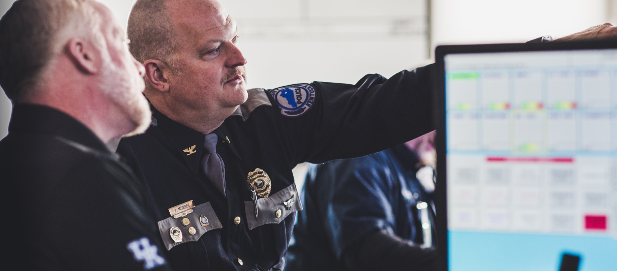 Police officers looking at security information