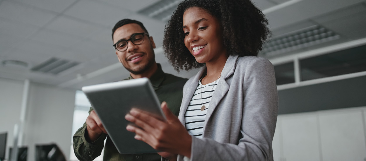 Two business people consult tablet