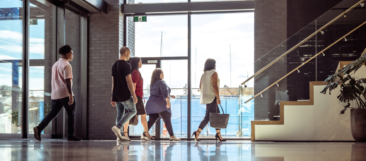 People walking through building lobby