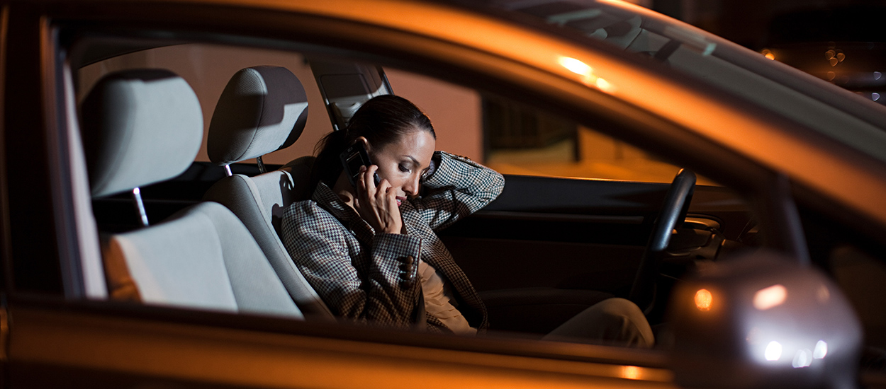 Woman calls on cellphone in parked car