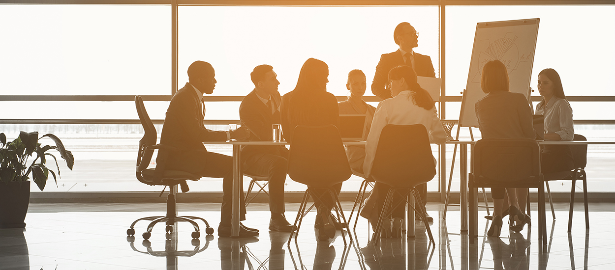 employees meeting by a large window