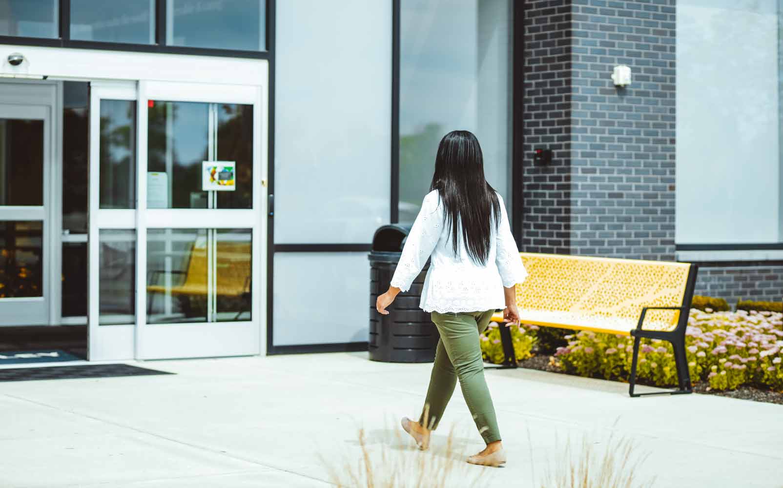 Woman approaches automatic doors