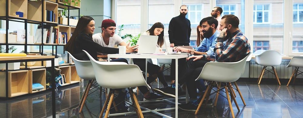 Employees work at a round table