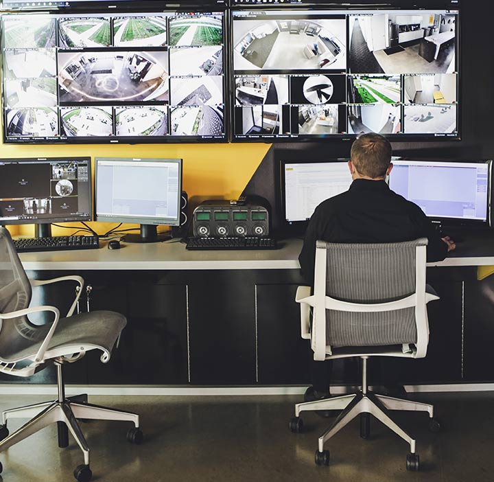 Man sits at remote security station