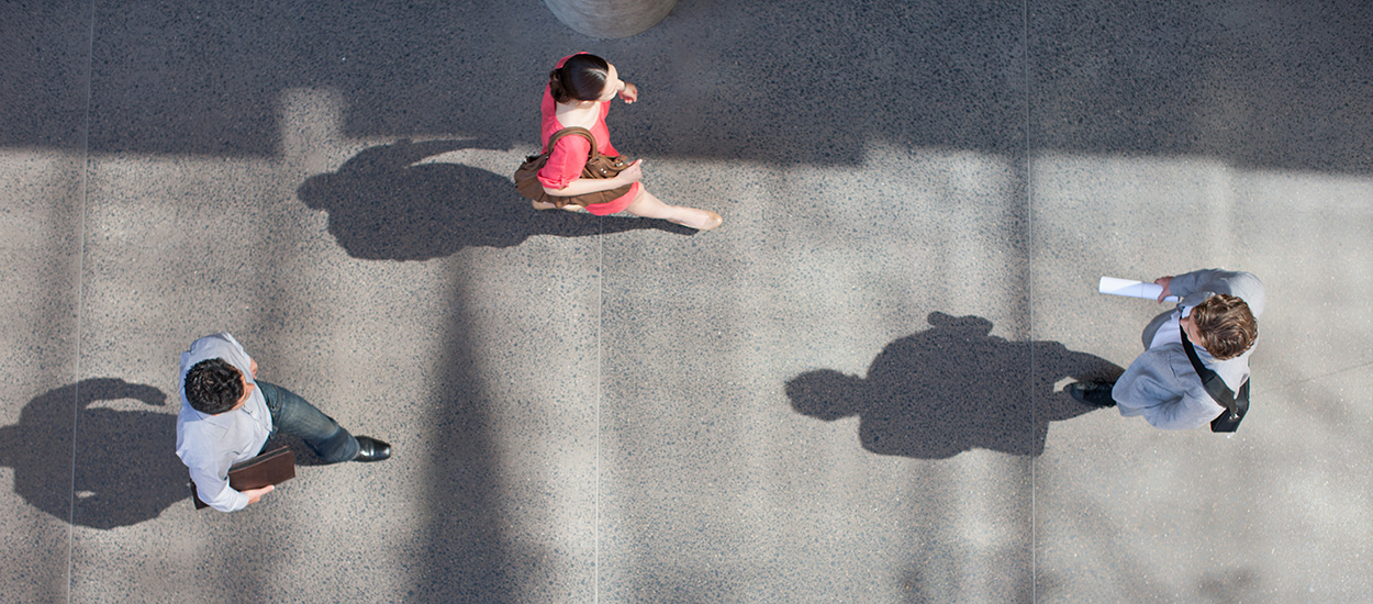 Aerial view of people walking on pavement