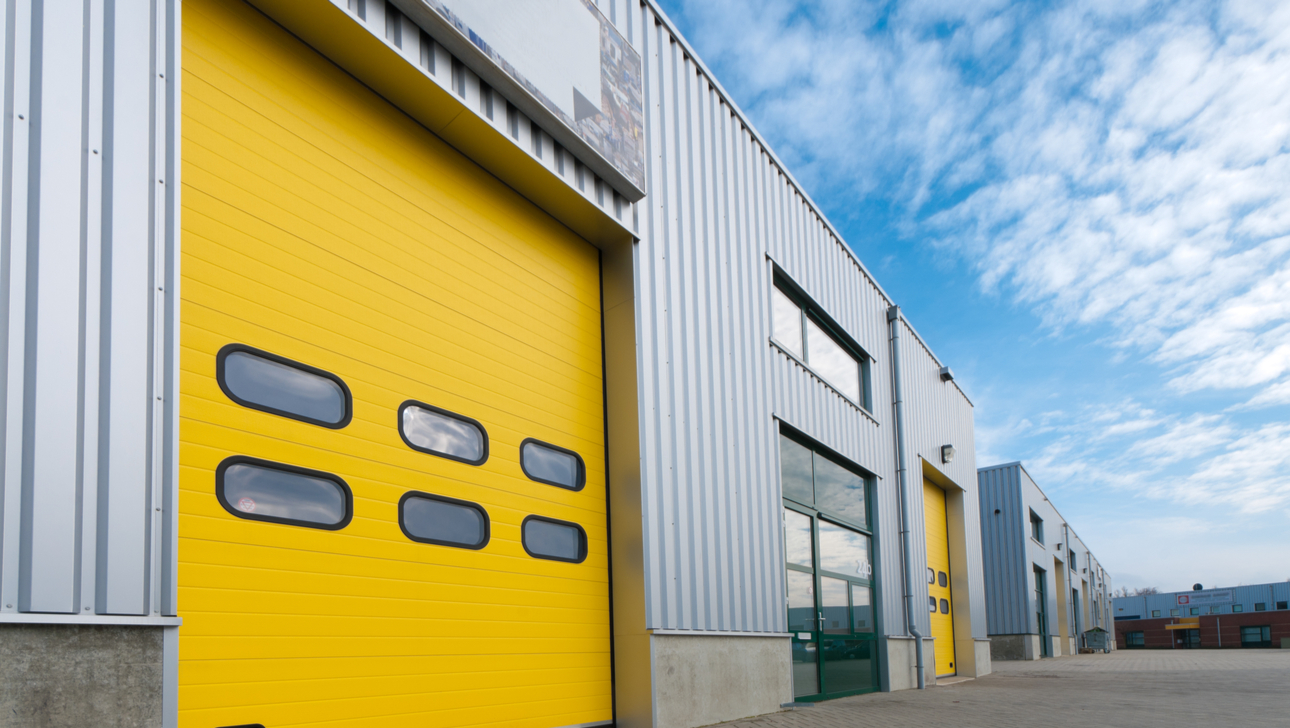 industrial warehouse with green and yellow roller doors