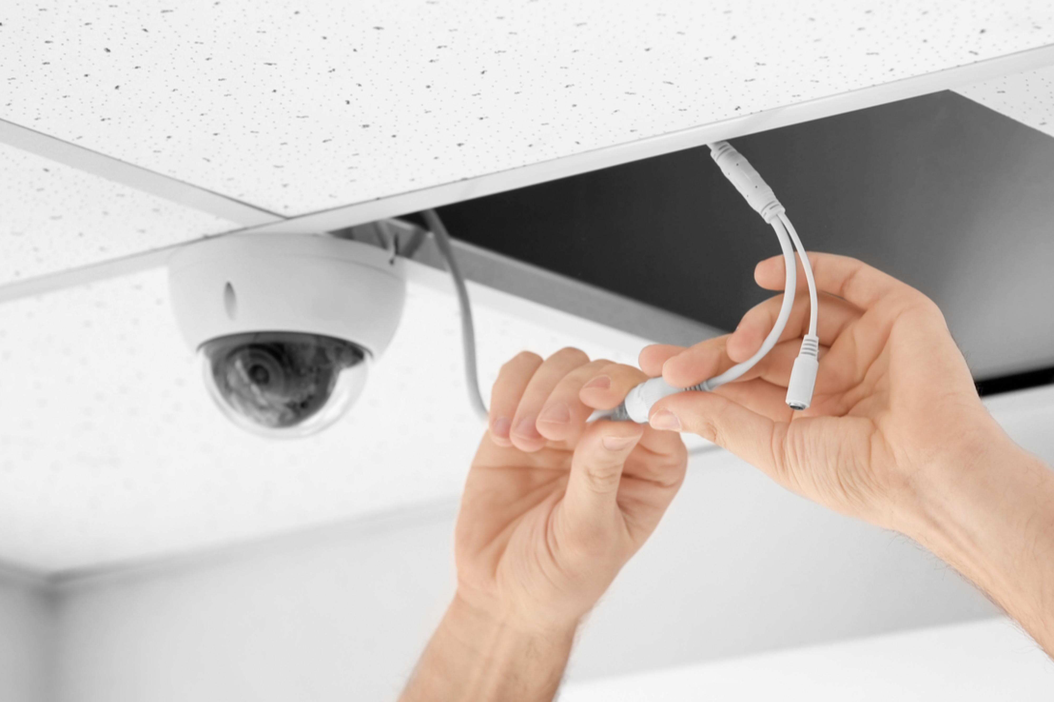 security camera installation in ceiling by technician 