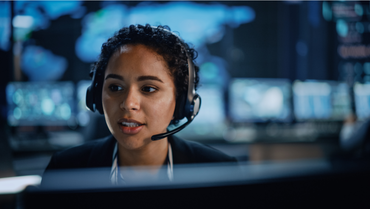 Female operator in alarm response centre talking into headset.png