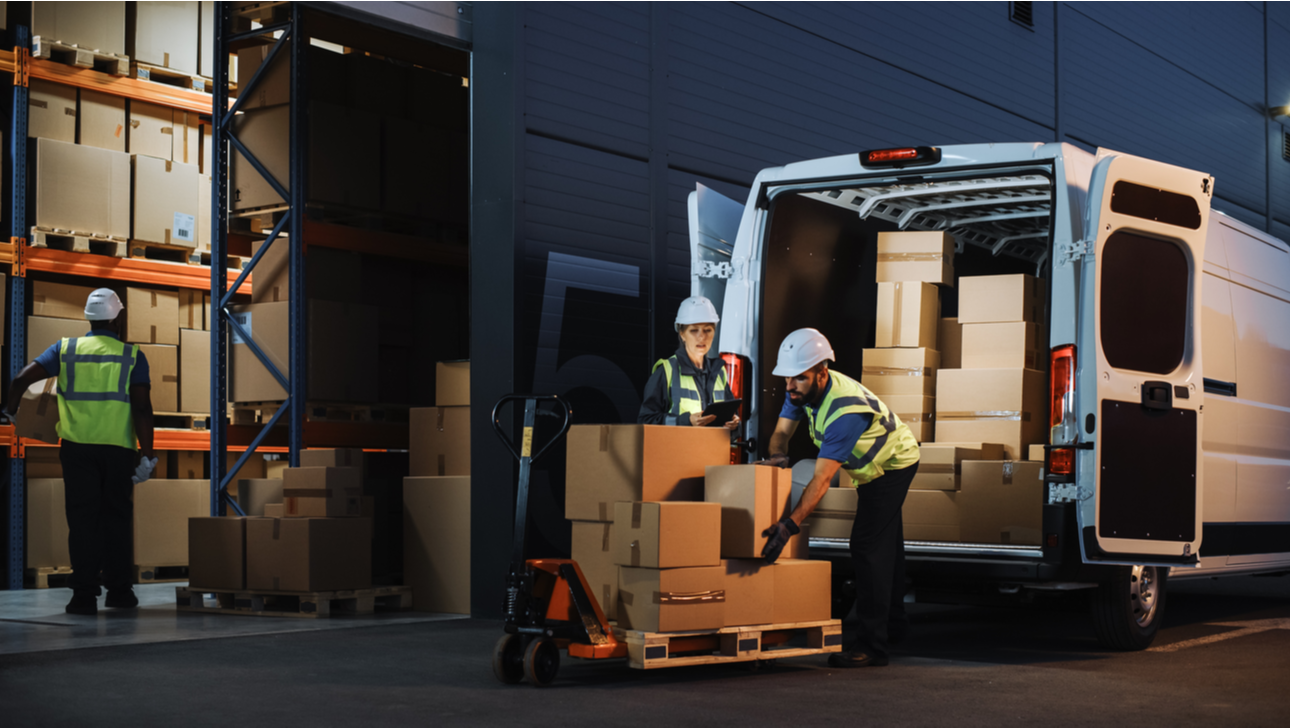 Outside of Logistics Retail Warehouse With Inventory Manager Using Tablet Computer.png