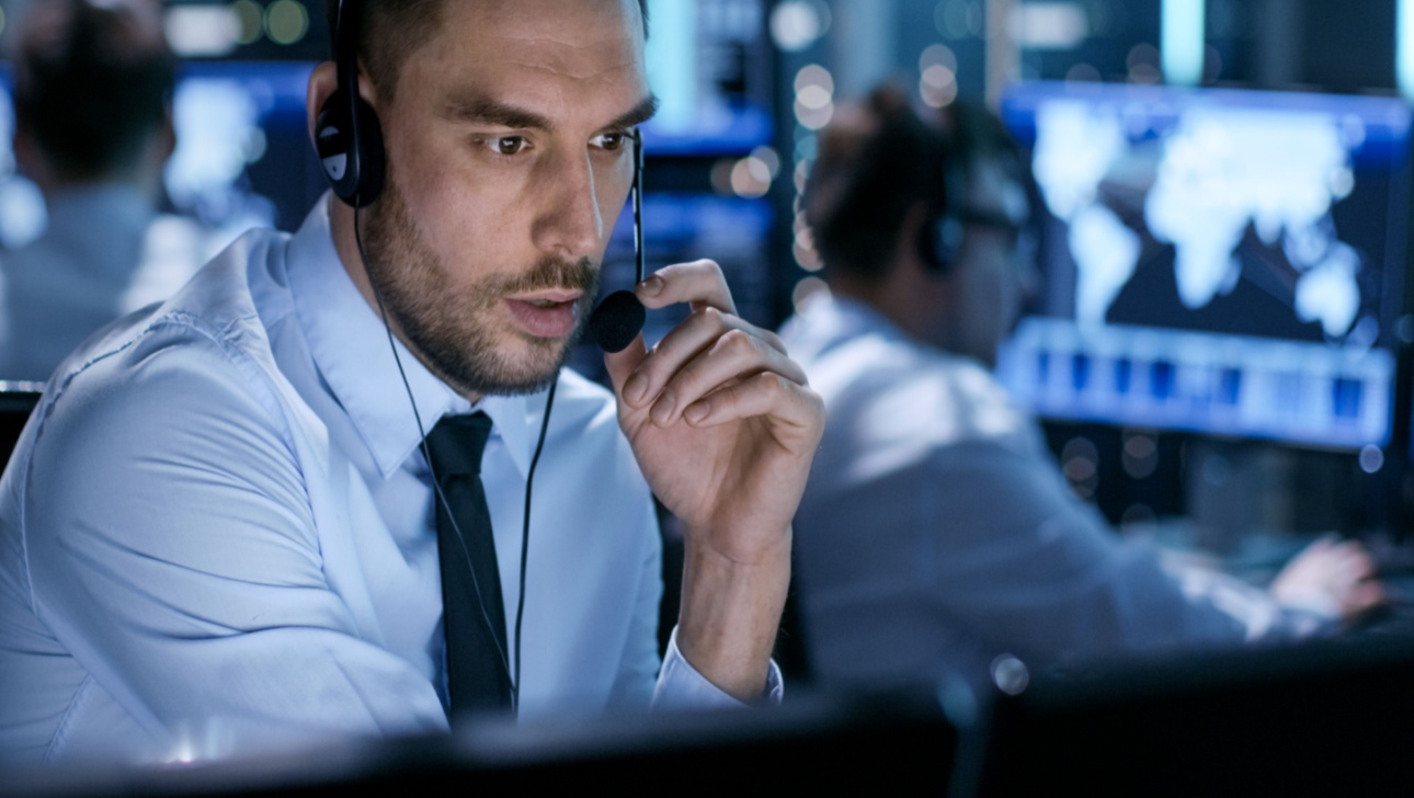 In System Control Center Technical Support Specialist Speaks into Headset.jpg