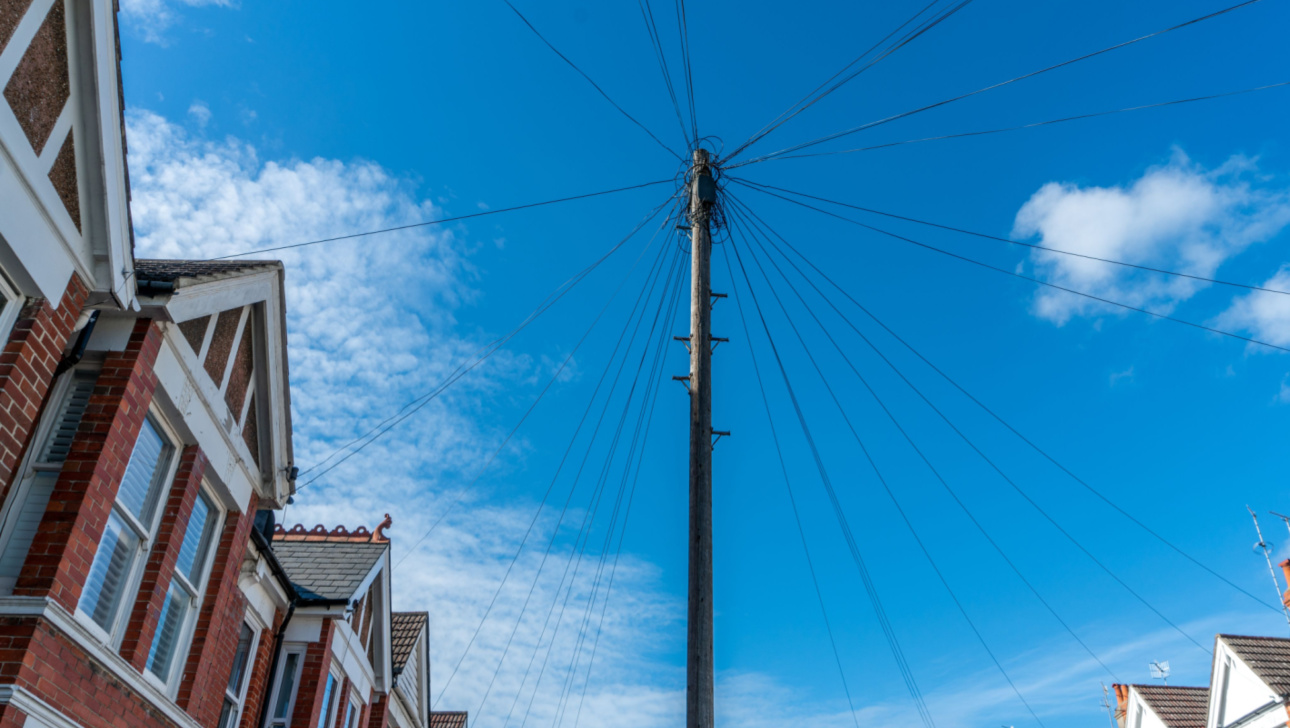 Old vintage wood telephone poles cable construction style in townhouse area in UK (3).jpg