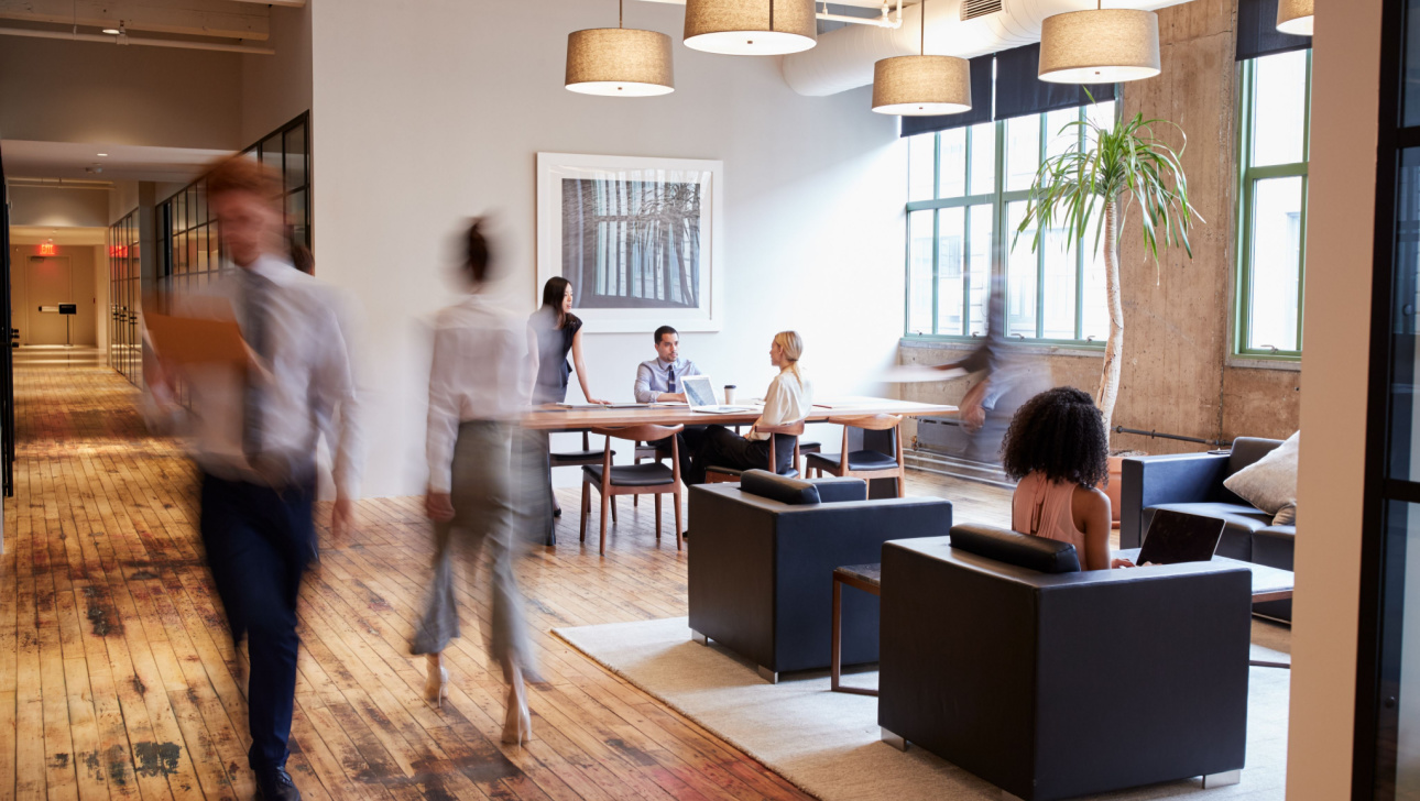 Business people at work in a busy luxury office space