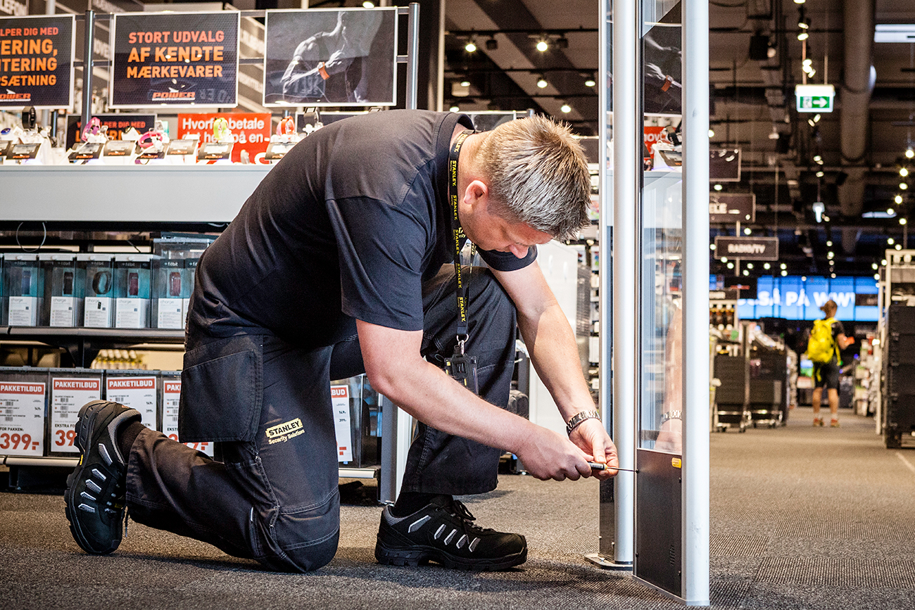 Photo of technician installing Electronic Article Surveillance in a Retail store