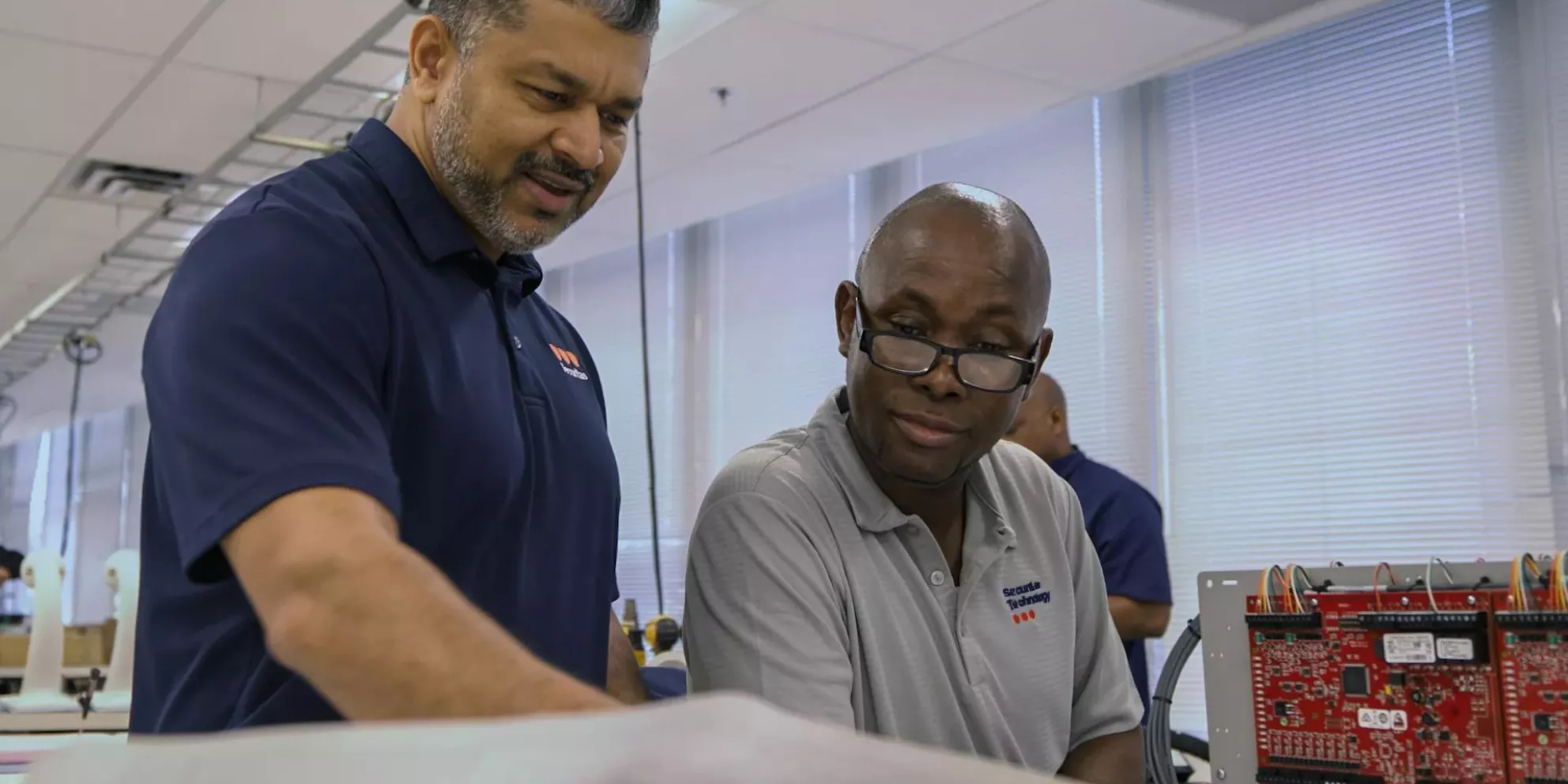 Manager and engineer talking in lab.