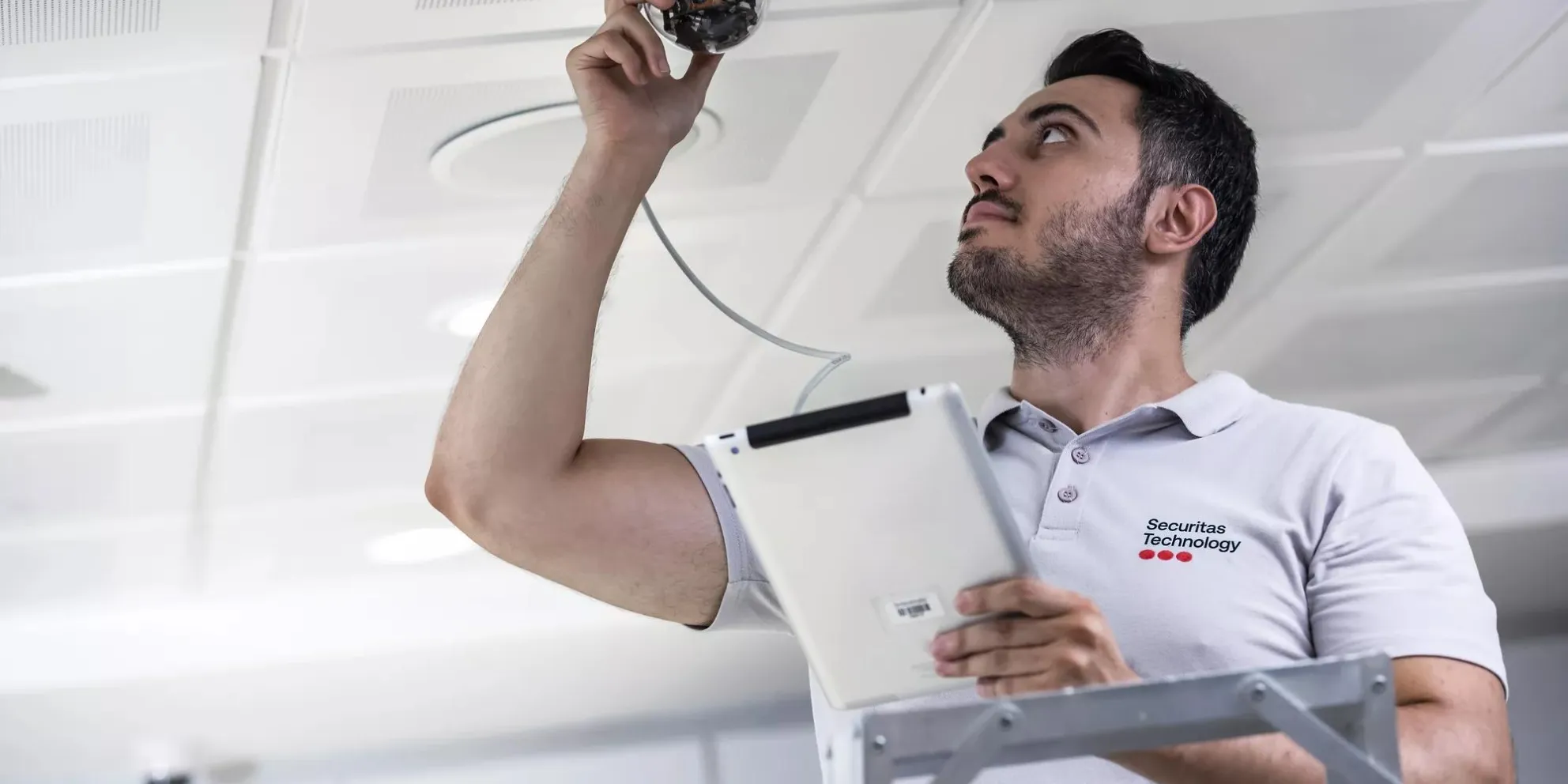 Securitas technician installing security camera
