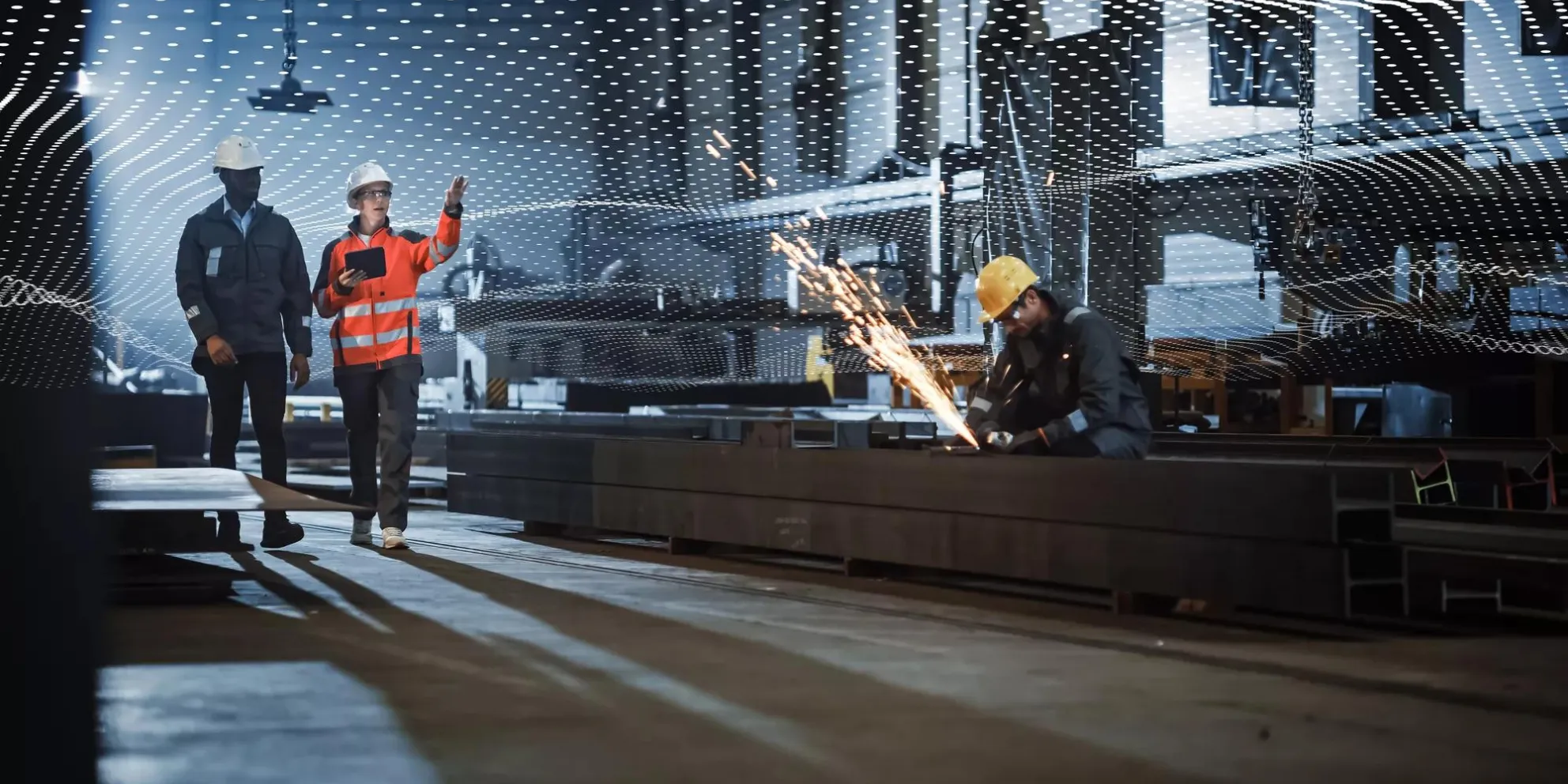 Two Heavy Industry Engineers Walk in Steel Factory, Use Tablet and Discuss Work. Industrial Worker Uses Angle Grinder in the Background. Black African American Specialist Talks to Female Technician.