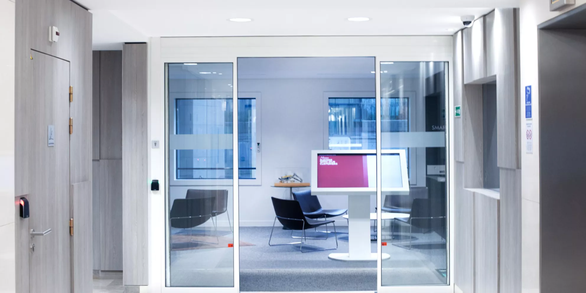 Elevator lobby outside of office with glass doors