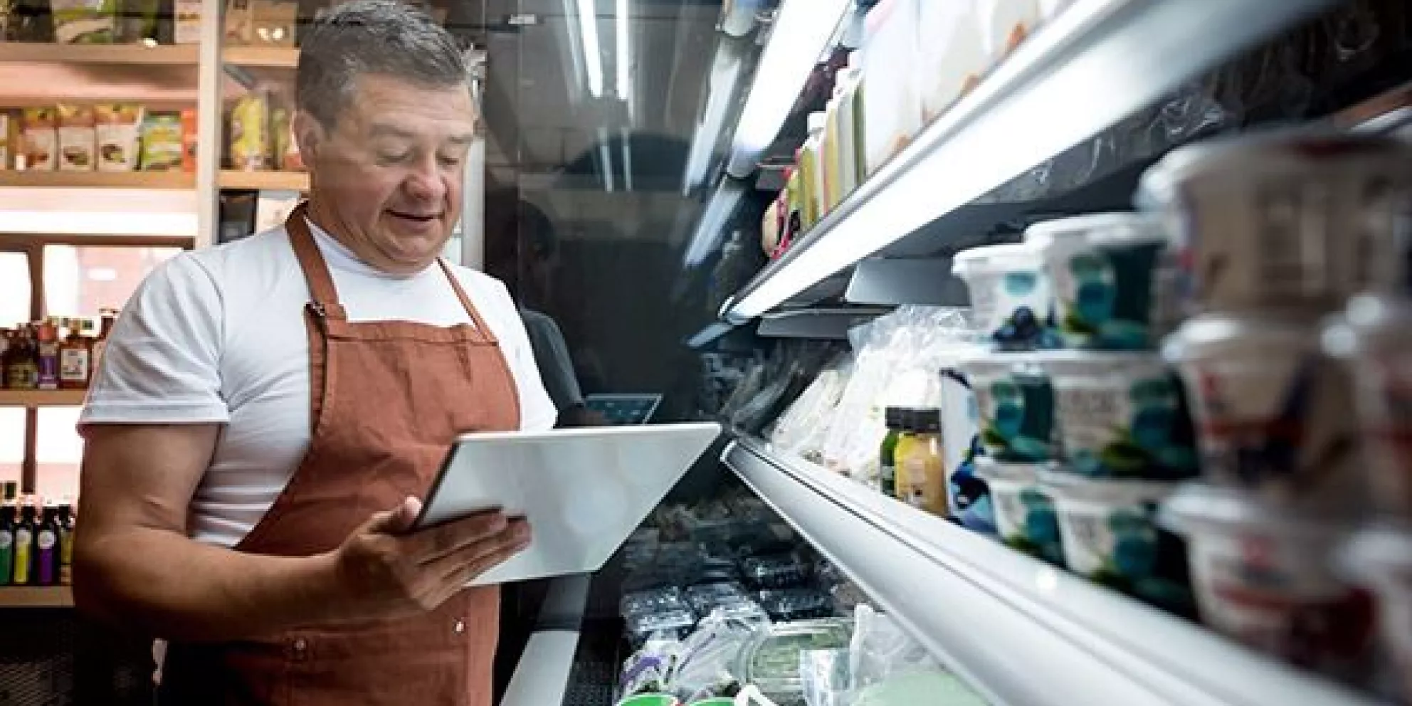 Small grocery owner with tablet