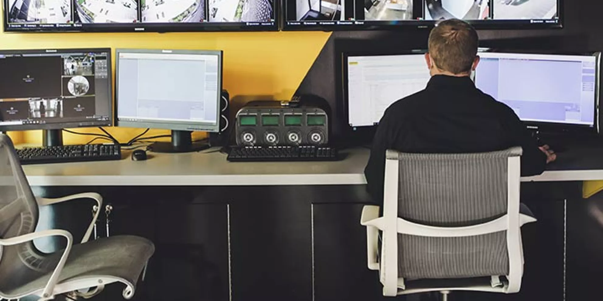 Man sits at remote security station