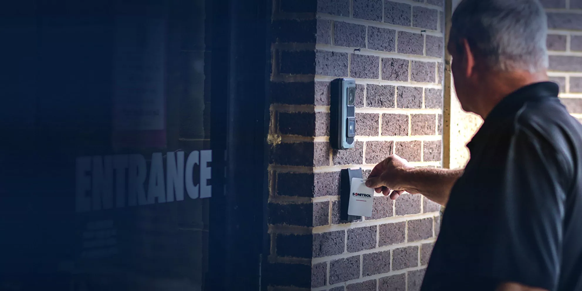 Man uses access control card reader to enter building