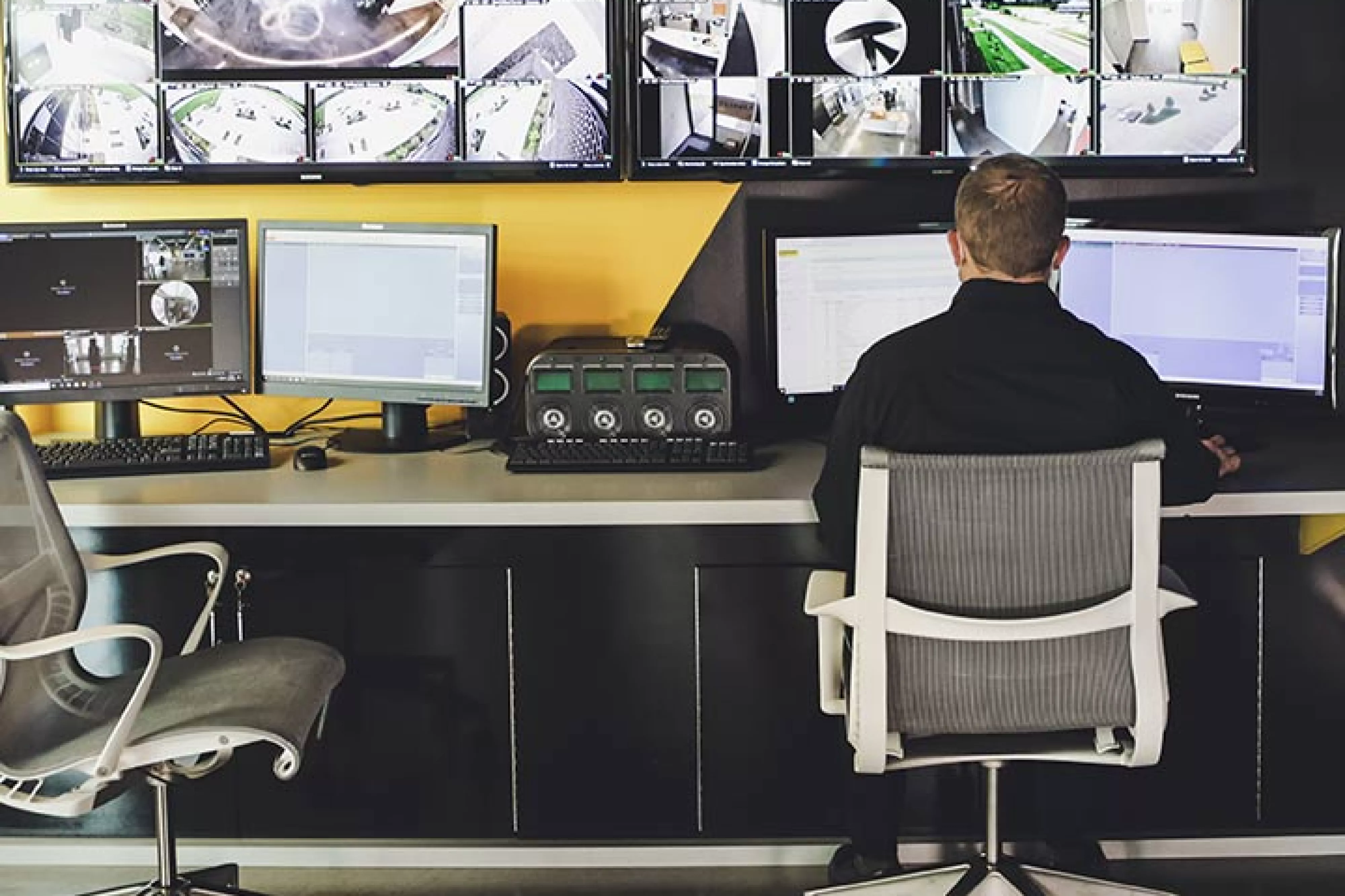 Man sits at remote security station