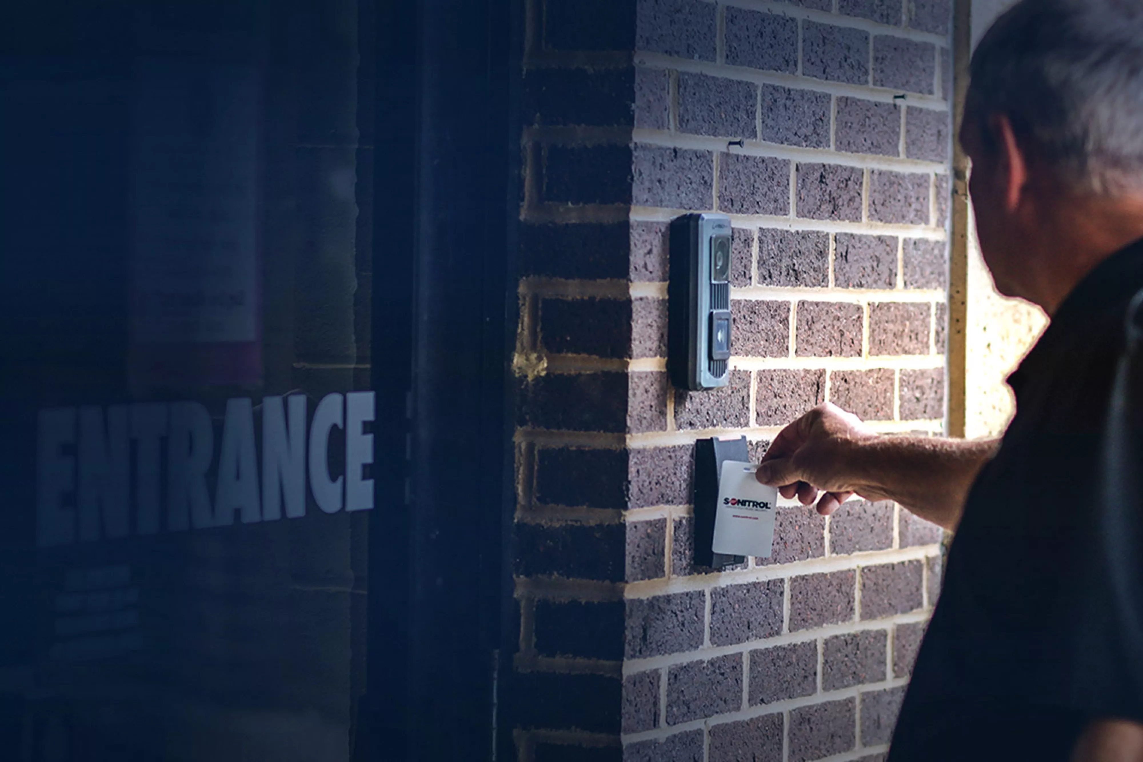 Man uses access control card reader to enter building