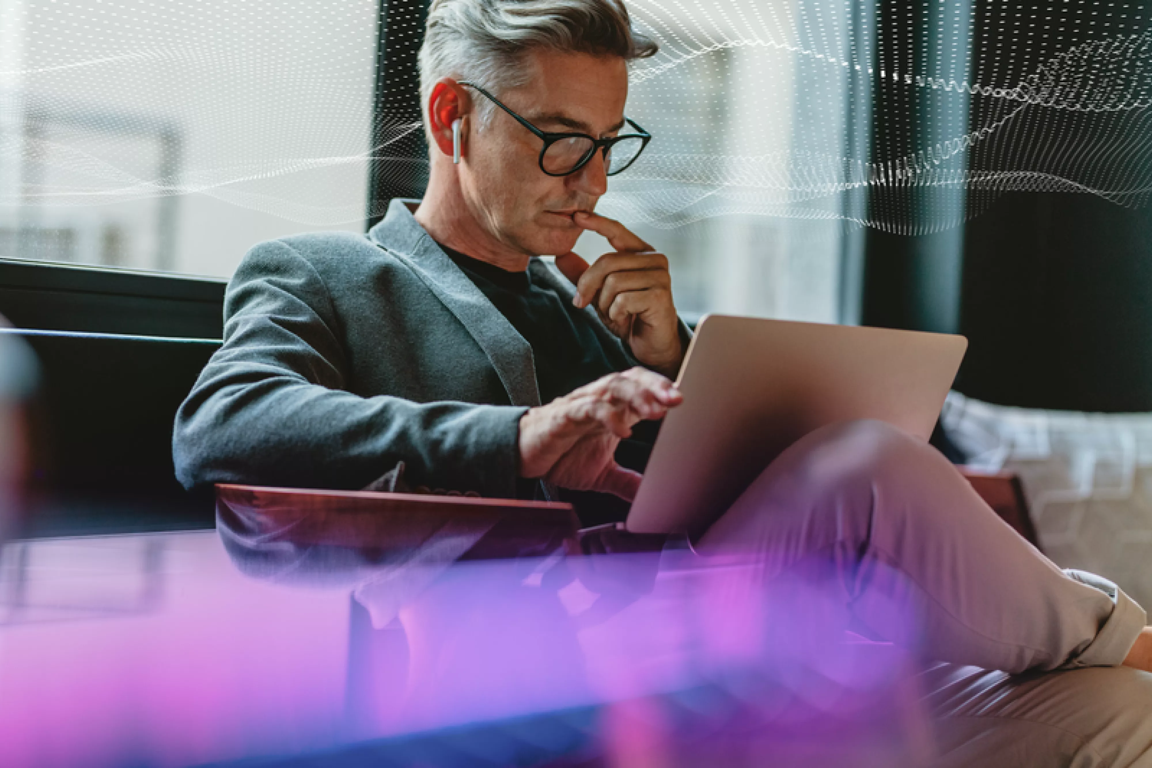 SecTech_2022_ManOnLaptop_AdobeStock_336028070_DOTS_PURPLE_EDIT