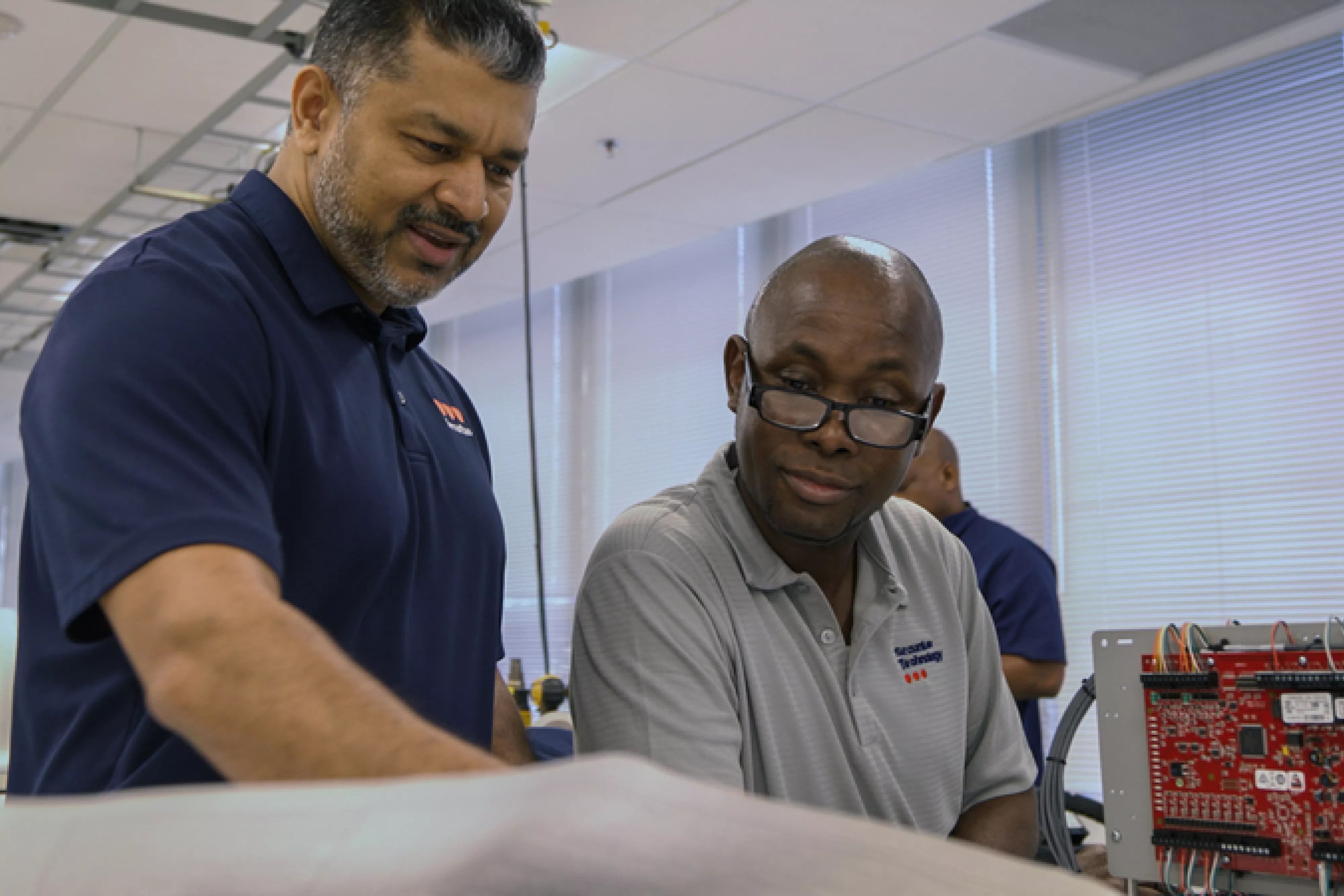 Manager and engineer talking in lab.