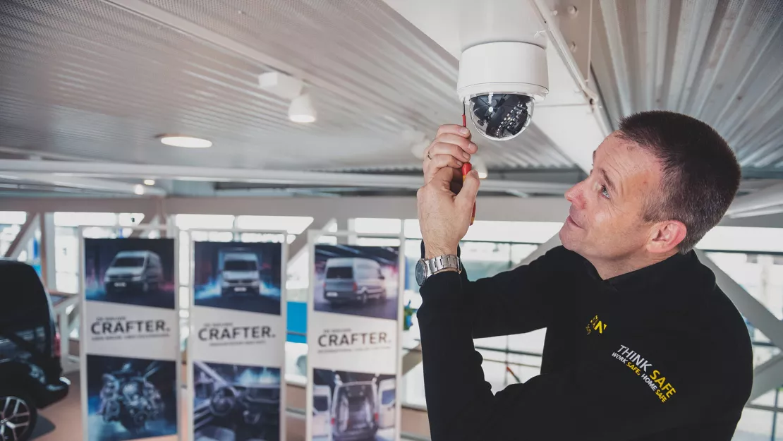 Man installs security camera in car dealership