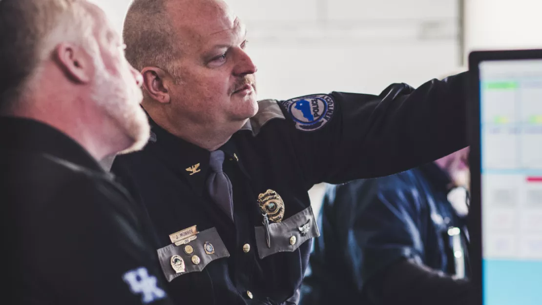 Police officers looking at security information