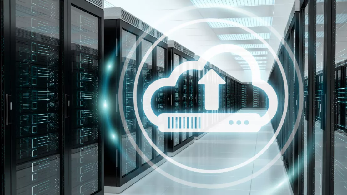 Graphic of cloud upload symbol on photo of server room