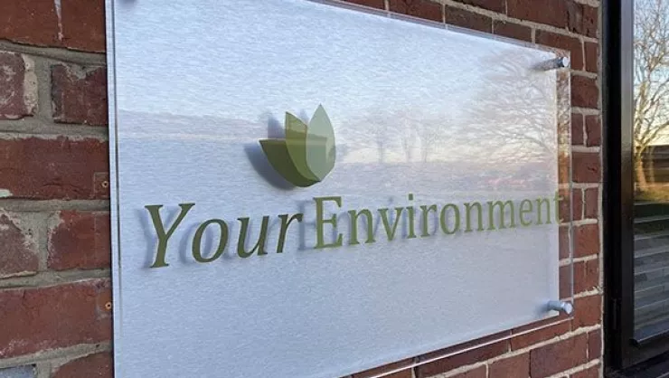 Your Environment sign on brick wall.