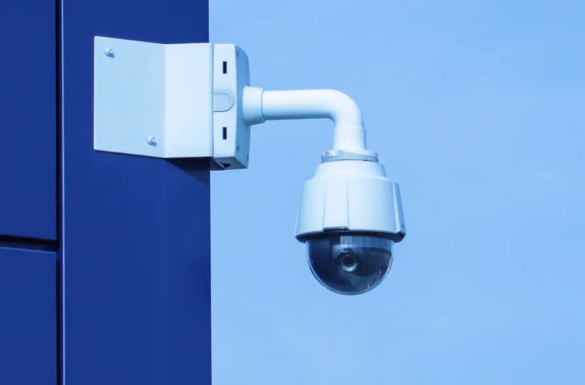 Video camera mounted on blue building