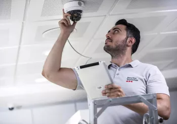 Securitas technician installing security camera