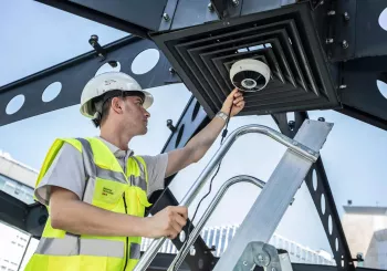 security technician installing business security camera