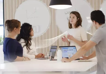 business associates standing around a conference table