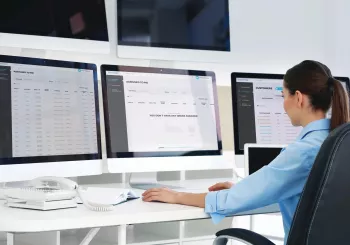 employee managing professional business security solutions on a desktop computer