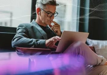 SecTech_2022_ManOnLaptop_AdobeStock_336028070_DOTS_PURPLE_EDIT
