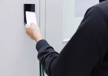 Man taps access control security pad 