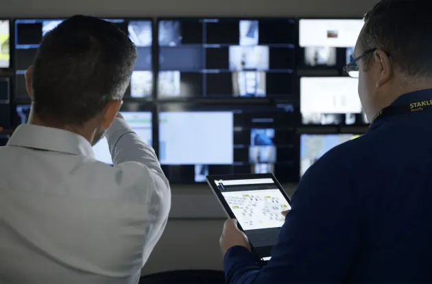 security officers remotely monitoring live security footage 