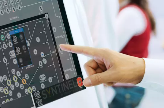 close up of finger pointing at syntinel screen