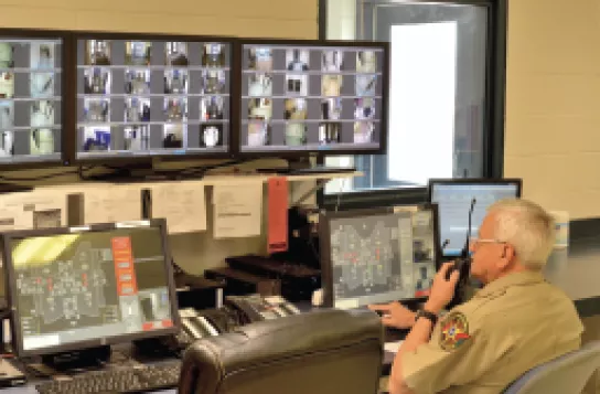 prison security employee at monitor station